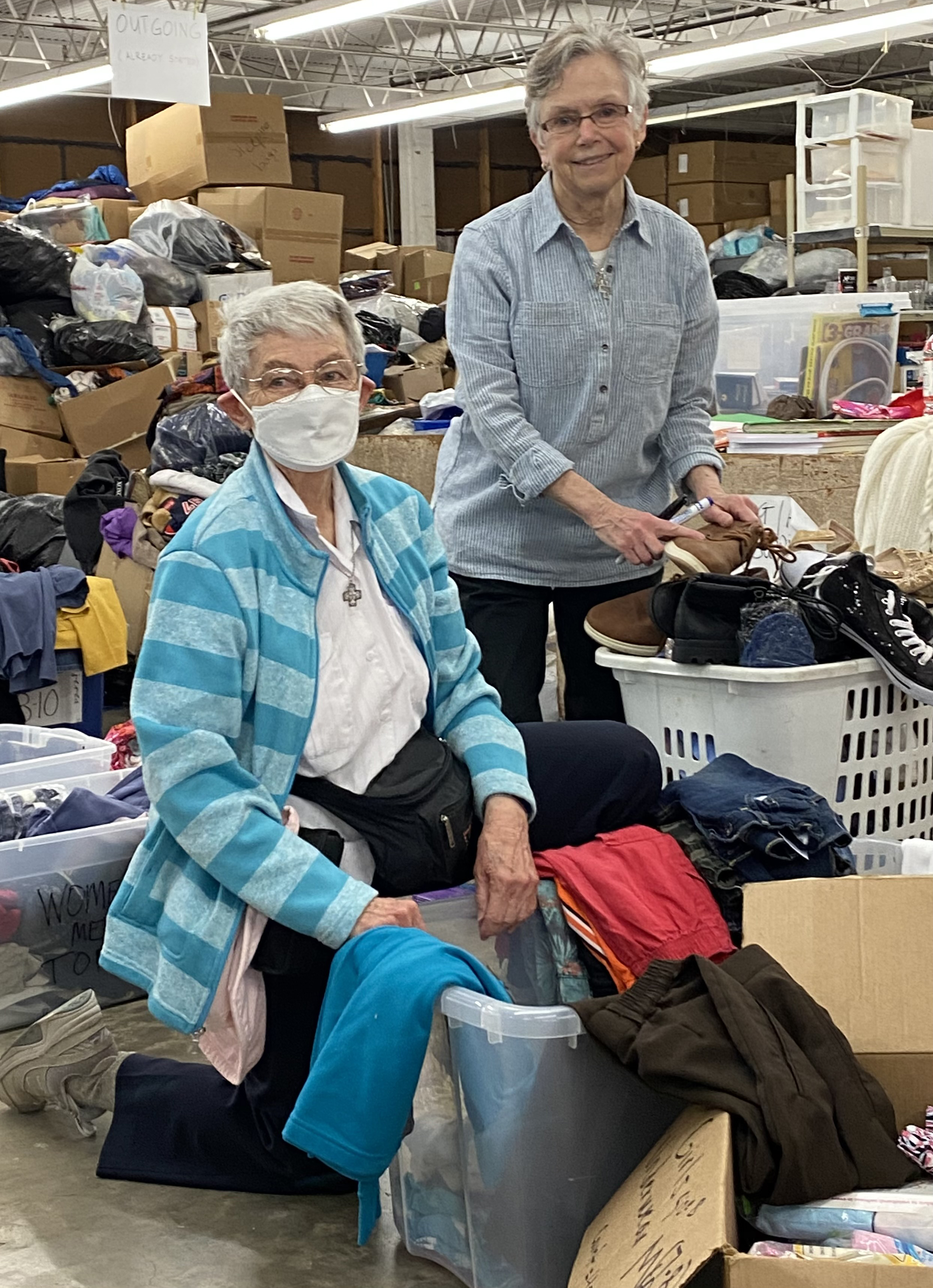 Mary Pung and Rita Ann.Sorting Clothes