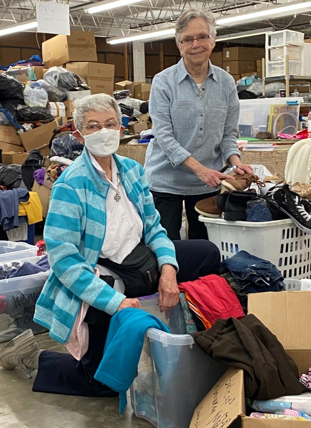 Mary Pung and Rita Ann.Sorting Clothes